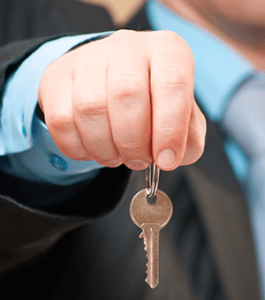 A businessman holding a key