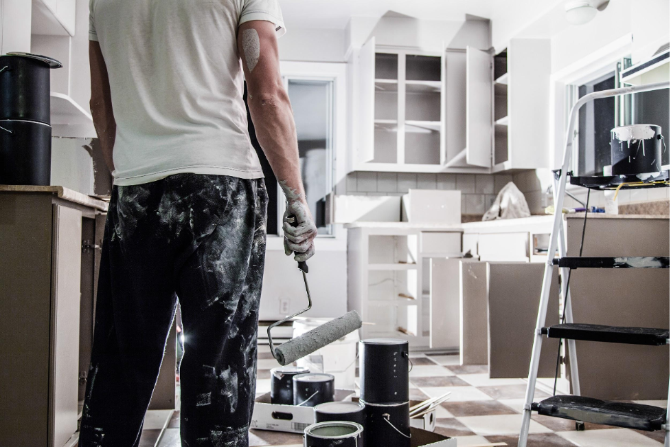 Man's back in recently painted kitchen to update real estate investment