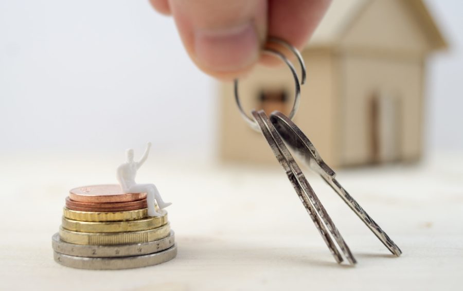 Hand holding keys of new real estate investment